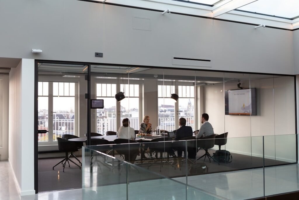 Colleagues in a boardroom discussion around a meeting table