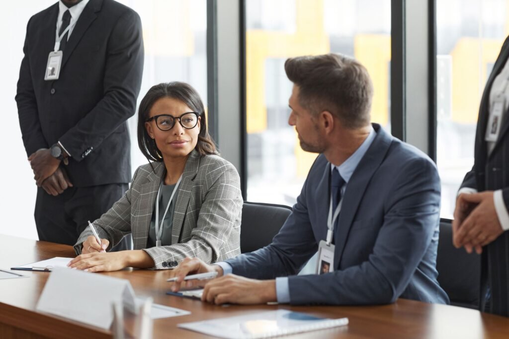 Two directors testing a proposal across the board table