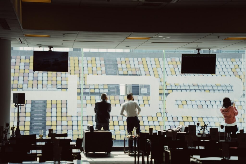 A team working in a darkened operations centre in front of a large monitoring screen wall