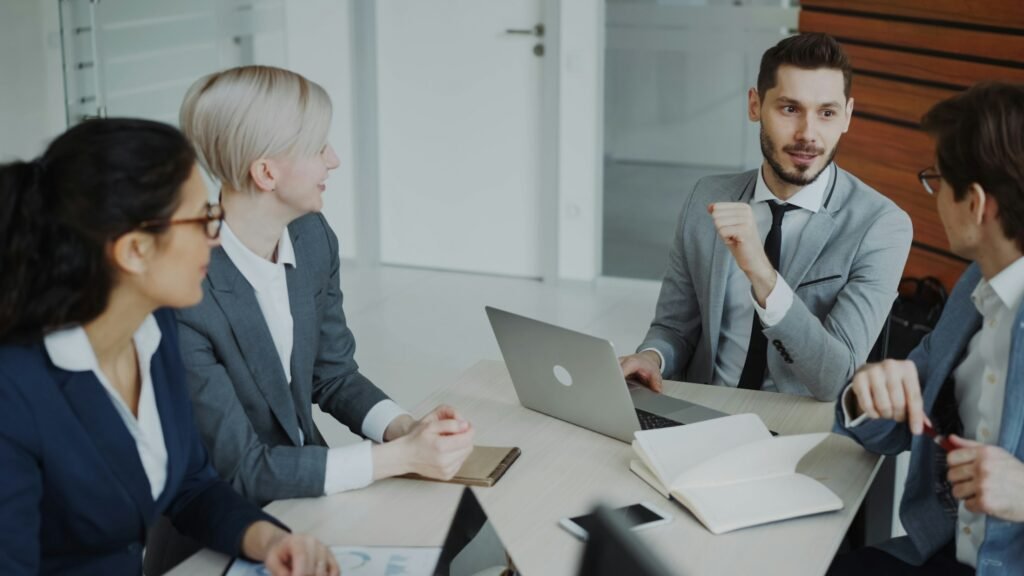 A group around a meeting table working through documents and laptops in a security review